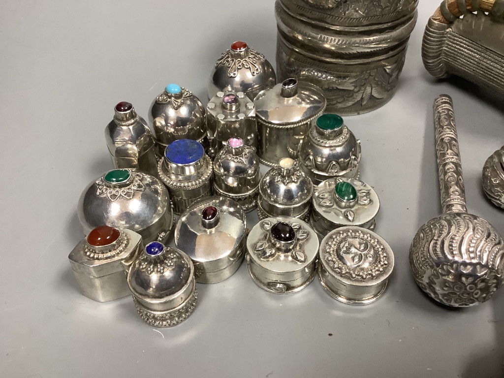 Sixteen Omani decorative silver trinket boxes, inset various semi-precious stones, a wide embossed bangle, a pair of 'cuff' bangles and three other items